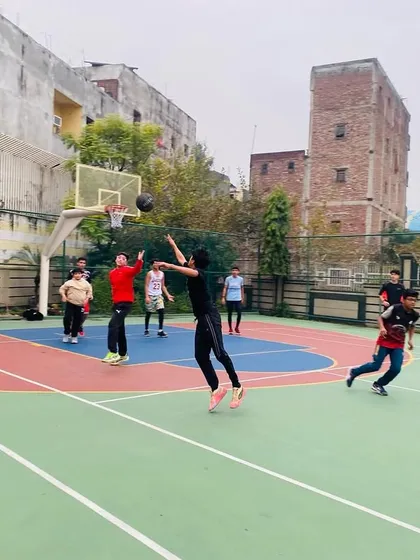 A female player takes a jump shot, demonstrating her skills.