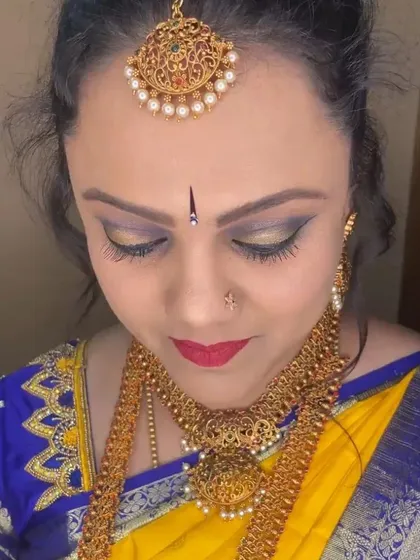 A close-up view of my makeup artistry. This look features a blended gold and black smokey eye with a sharp wing and a bold red lip, creating a powerful and traditional aesthetic for this festive occasion.