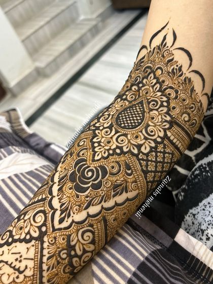 A close-up of the upper portion of Afreen's bridal henna, with her name beautifully integrated.