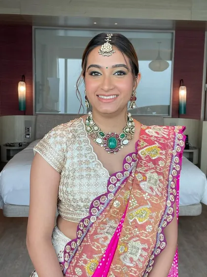 The client looking fresh and radiant for her Haldi ceremony. The high ponytail is a practical and stylish choice for this fun-filled event.
