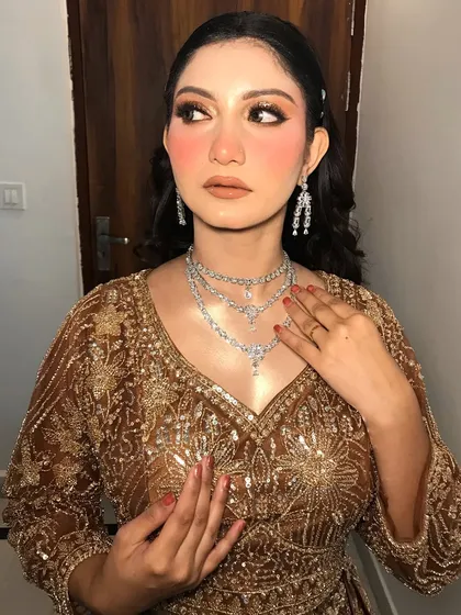 A playful pose showing off her red nails and the sparkling diamond jewelry.