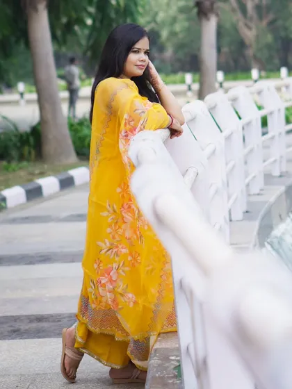 Another example of an outdoor portfolio shoot. The bright yellow traditional outfit stands out against the park background, and the pose is natural and unposed, showing a different side of my work.