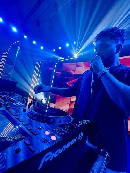 On the mic, interacting with the crowd. I believe in being more than just a DJ; I'm a performer who engages directly with the audience.