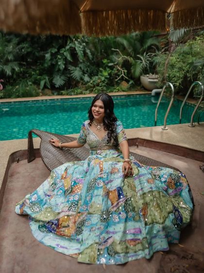 A relaxed and happy shot by the pool. The makeup is light and summery, perfect for a daytime event in a beautiful resort setting.
