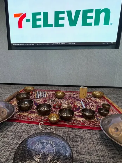 This was my setup for a sound healing session at the 7-Eleven office. I bring a variety of instruments, including handpans and Tibetan singing bowls, to create a rich, multi-layered soundscape that promotes deep relaxation.