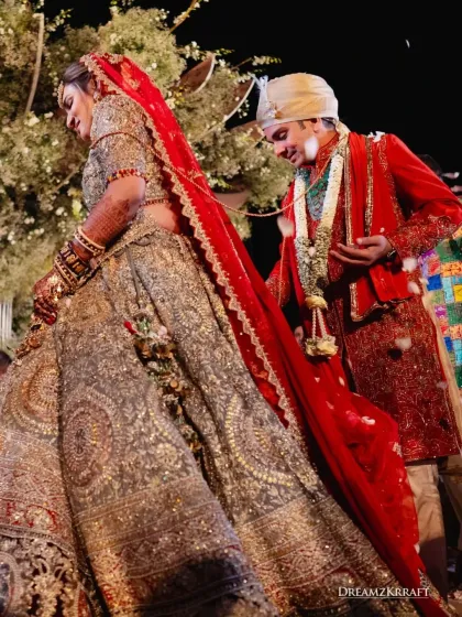 The couple takes their first steps together after the Varmala. The intricate details of the bride's lehenga and the groom's sherwani are part of the visual story I help create.