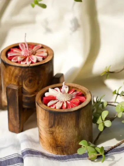 These wooden jar candles with red flower embeds bring a touch of nature indoors. The dark wood contrasts beautifully with the vibrant red flower, making it a cozy and stylish addition to any room.