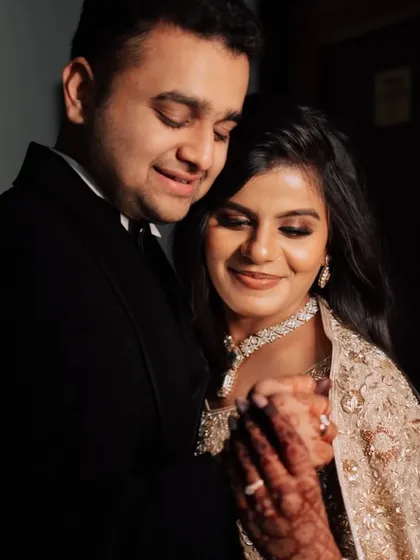 A romantic moment between the couple at their sangeet. The bride's soft glam makeup looks beautiful in this intimate shot.