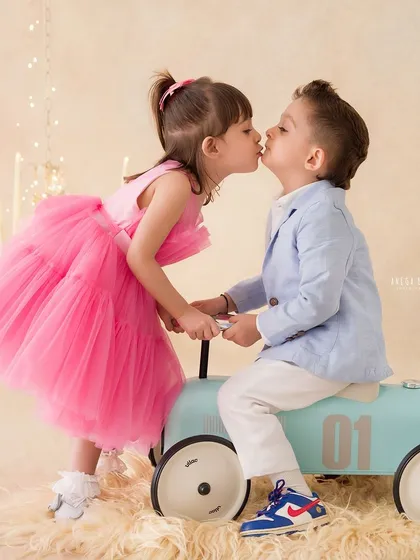 A sweet kiss between siblings, a memory frozen in time. These are the innocent, unprompted moments of love that I aim to preserve forever in my child photography sessions.