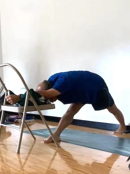 A demonstration of Ardha Chandrasana (Half Moon Pose) against a wall with chair support. This is an excellent way to learn the alignment of the pose without worrying about balance.