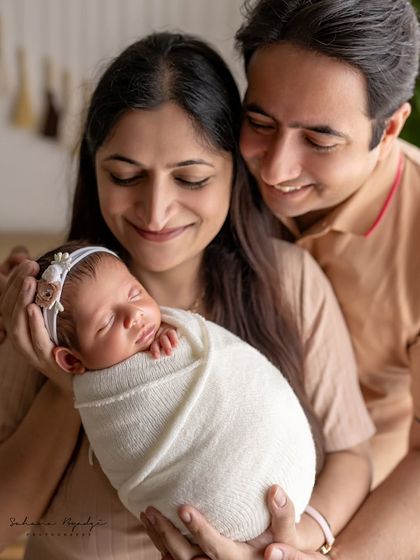 A close-up of new parents adoring their sleeping baby. These are the quiet, tender moments that I love to document.