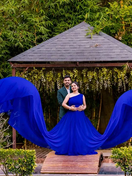 A stunning shot of a flowing blue gown at our garden gazebo, creating a wing-like effect.