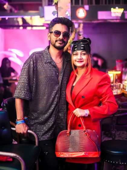 A stylish couple enjoying the vibe at Happy Brew. My curated guestlist ensures a great mix of people.