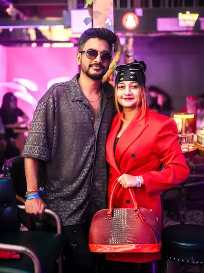 A stylish couple enjoying the vibe at Happy Brew. My curated guestlist ensures a great mix of people.