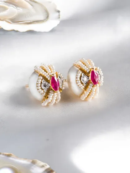 Details define a piece. These earrings from the Garden of Pearls collection feature sculpted pearls, soft curvature, and precise diamond and ruby placement, creating a design that feels both classic and contemporary.