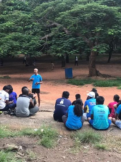An outdoor briefing session with the group. Here, one of our experienced runners shares some wisdom before we head out. We believe in learning from each other's experiences.