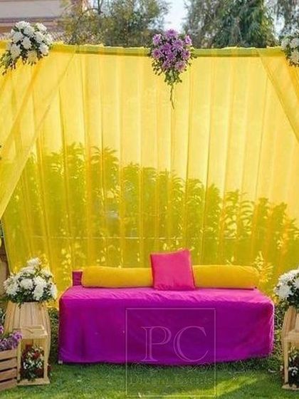 A simple yet elegant outdoor Haldi setup. I used a bright yellow drape with purple and white floral bunches, creating a beautiful contrast for this garden ceremony.