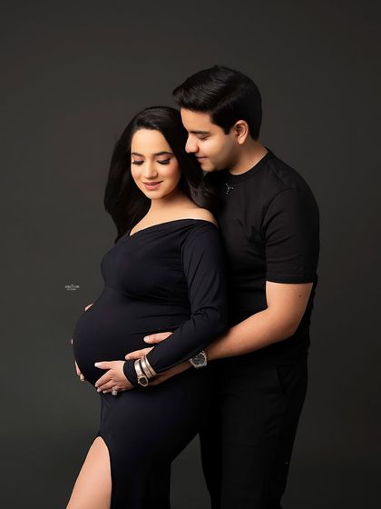 A classic maternity pose, with the partner lovingly holding the mamma and her baby bump. It’s a simple, sweet, and perfect shot.