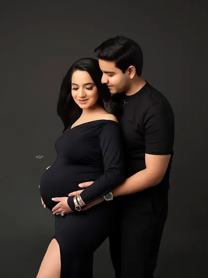 A classic maternity pose, with the partner lovingly holding the mamma and her baby bump. It’s a simple, sweet, and perfect shot.