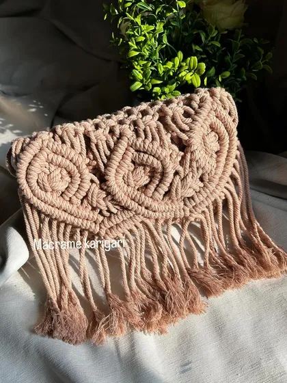 This shot showcases the beautiful texture and fringing of our macramé owl bag. Each tassel is hand-finished to complete the look.