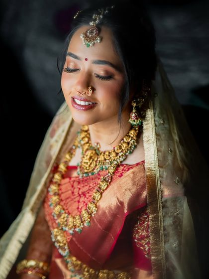 A serene, eyes-closed shot in the warm light, her makeup glowing.
