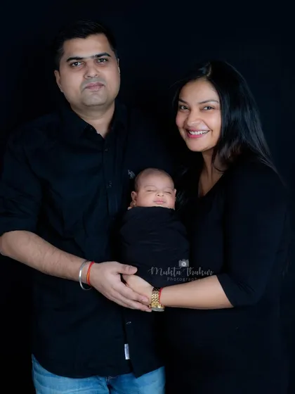A complete family portrait with the newborn smiling peacefully. These are the moments that make my job so rewarding.
