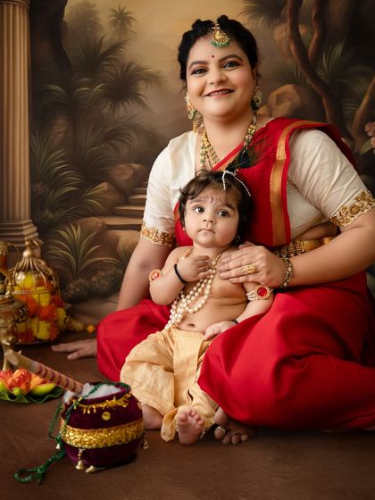 A close-up portrait capturing the sweet connection between mother and child, with the baby looking directly at the camera.