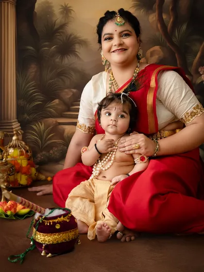 A close-up portrait capturing the sweet connection between mother and child, with the baby looking directly at the camera.
