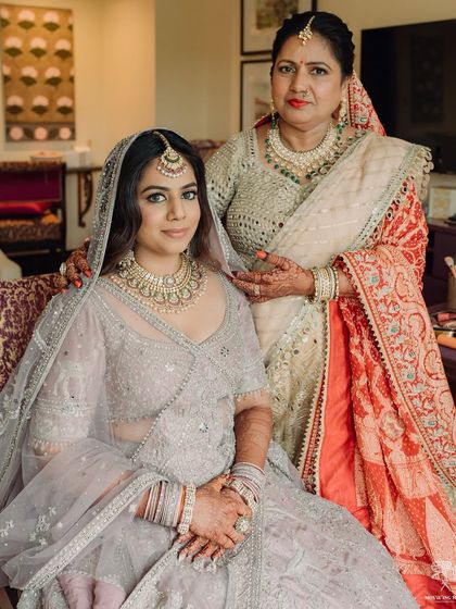 A touching portrait of the bride with her mother, both looking elegant and happy.
