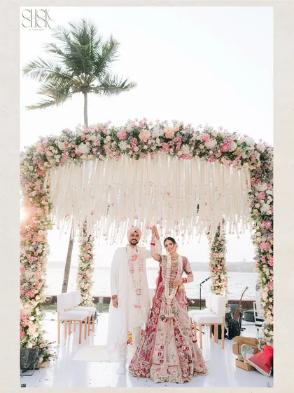 A destination wedding in Goa, with the sea as a witness. This wide shot captures the scale and beauty of a beach wedding ceremony, from the stunning floral mandap to the serene backdrop. It shows our expertise in handling large-scale destination weddings and creating breathtaking compositions.