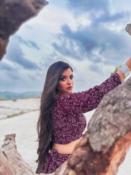 This wine-coloured lehenga with a full-sleeve, embroidered crop top is a chic and modern choice. The deep colour and intricate work make it a sophisticated option for an evening event.