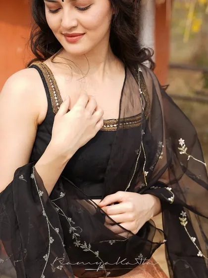 A closer look at the delicate floral embroidery on the black organza dupatta and the simple, elegant design of the blouse.