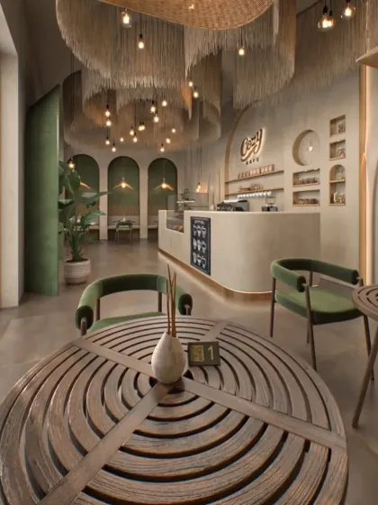 This cafe interior uses natural materials like rattan and wood to create a warm, bohemian-inspired atmosphere. The large, oversized pendant lights are a key feature, adding texture and a soft glow to the space.