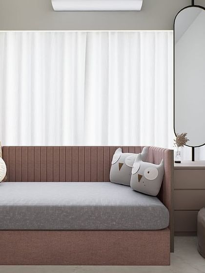 A modern minimalist bedroom with a soft pink daybed and a 'Good Vibes Only' neon sign. This space is designed to be a positive and uplifting personal corner.