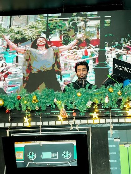 My AV setup for a New Year's Eve party, complete with festive decorations and visuals from classic Bollywood dance numbers.