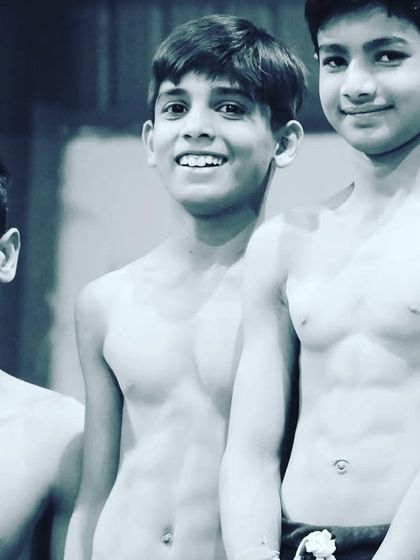 The physique of a gymnast is built through years of dedicated training. Our young athletes show the results of their hard work.
