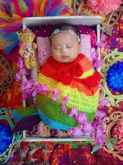 "Mohe rang do laal." This vibrant, colorful setup is perfect for celebrating Holi. The rainbow wrap and bright backdrop create a joyful and festive portrait for this little one's first Holi.