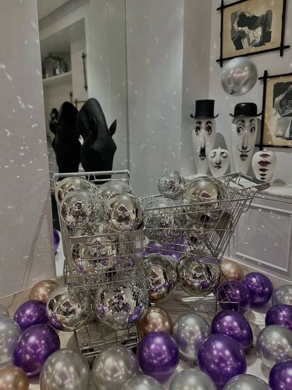 A fun and quirky detail from a disco-themed party, featuring mini shopping carts filled with silver disco balls. This shows how I can incorporate unique props to match any theme.