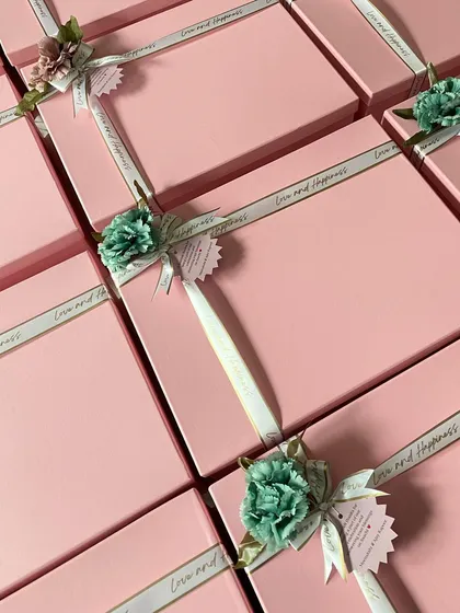 The packaging for these return favors was designed to be simple yet elegant. I chose a soft pink box with a custom "Love and Happiness" ribbon and a delicate floral accent.
