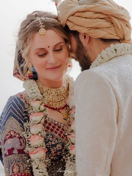 A tender moment, with the groom whispering to his bride.