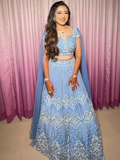 The full look, a beautiful blue lehenga paired with a romantic hairstyle.