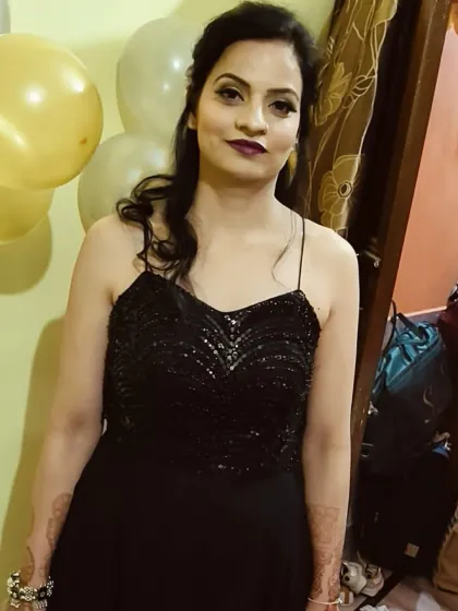 A simple and elegant black gown with a sequined bodice and spaghetti straps. A versatile option for any party.