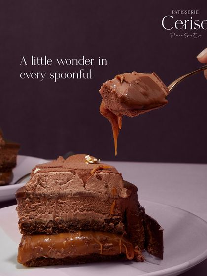 A spoonful of my Midnight Sun entremet, showing the gooey caramel dripping from the rich chocolate mousse. It is a little wonder in every bite, perfect for a Mother's Day celebration.