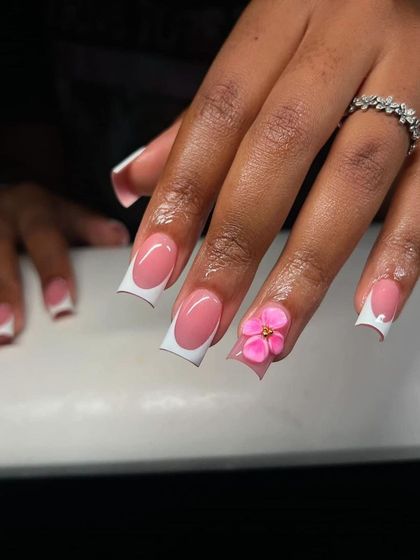 A square-tipped French manicure with a single, beautifully sculpted 3D pink flower. Sometimes, one perfect accent is all you need.