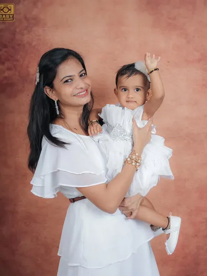 A mother and daughter duo, waving happily for the camera. A beautiful portrait of their connection.