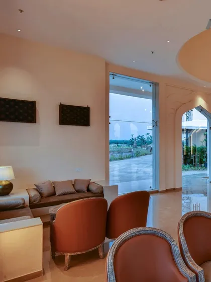 An interior view of the lobby at The Fern Sattva Resort. We used a palette of warm, natural materials and arranged the seating to create intimate conversational nooks within the larger, open space.