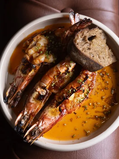 Scrumptious prawns served with a slice of fresh sourdough bread. This dish is packed with so much flavor, you'll definitely come back for more.