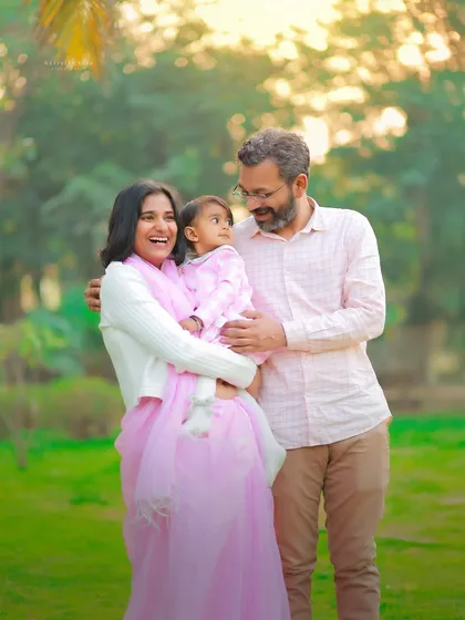 Capturing a moment of pure joy between parents and their child during a first birthday outdoor session. The soft, golden light makes this family portrait feel warm and full of love.