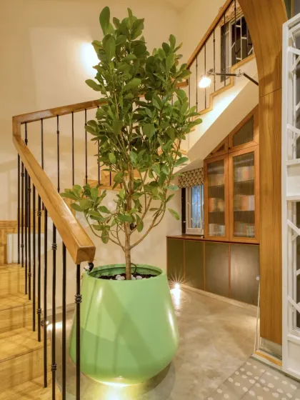 The same reading nook under the stairs, illuminated at night. This space shows how transitional areas can become destinations in themselves.