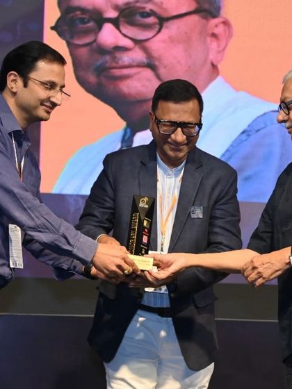 A moment of recognition as an award is presented at the Smart Space Awards, celebrating the collaboration between industry leaders.